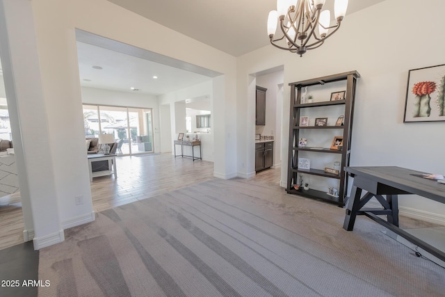 dining area with an inviting chandelier and light carpet