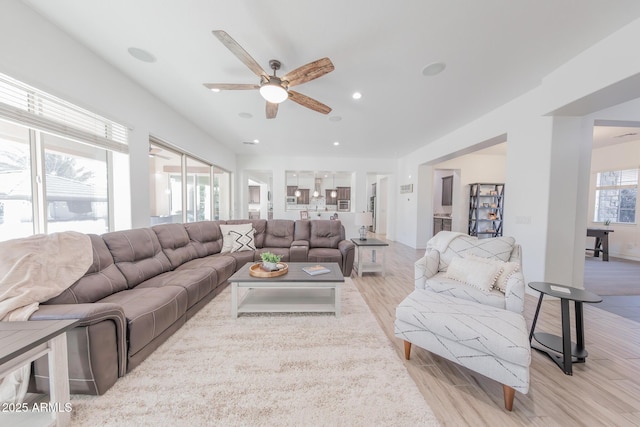 living room with ceiling fan, light hardwood / wood-style flooring, and plenty of natural light