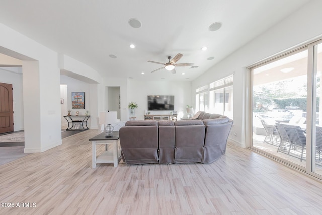 living room featuring ceiling fan and light hardwood / wood-style flooring