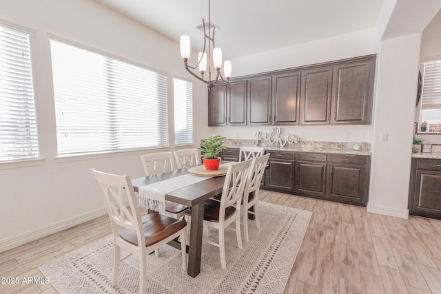 dining space featuring a chandelier and light hardwood / wood-style flooring