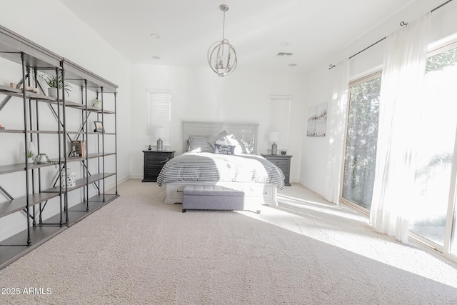 carpeted bedroom with a chandelier