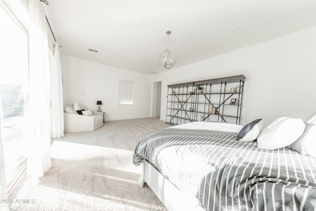 bedroom featuring a chandelier and light carpet