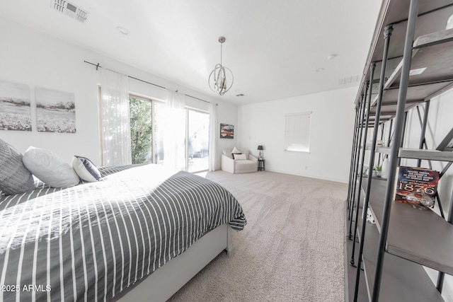 carpeted bedroom with a notable chandelier