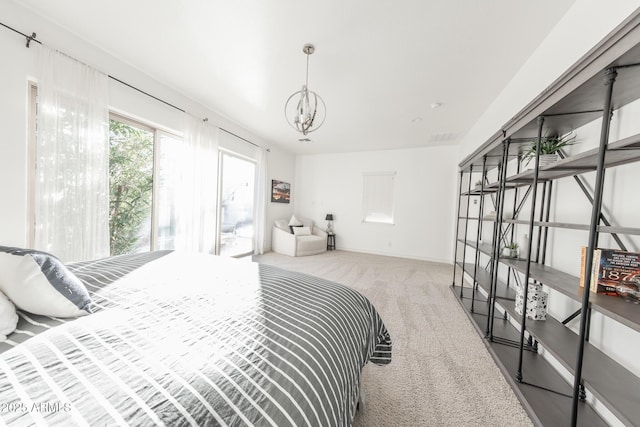 carpeted bedroom featuring a chandelier