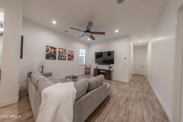 living room featuring light wood-type flooring and ceiling fan