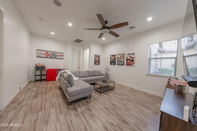 living room featuring ceiling fan and light hardwood / wood-style flooring