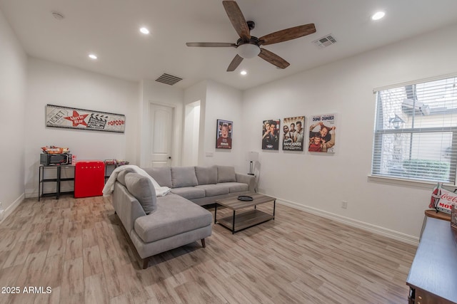 living room with ceiling fan and light hardwood / wood-style flooring