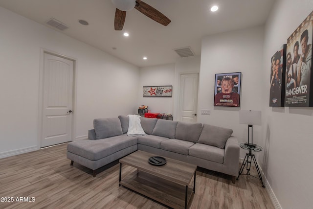 living room featuring ceiling fan and light hardwood / wood-style flooring