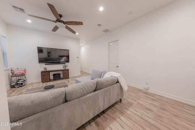 living room with light wood-type flooring and ceiling fan