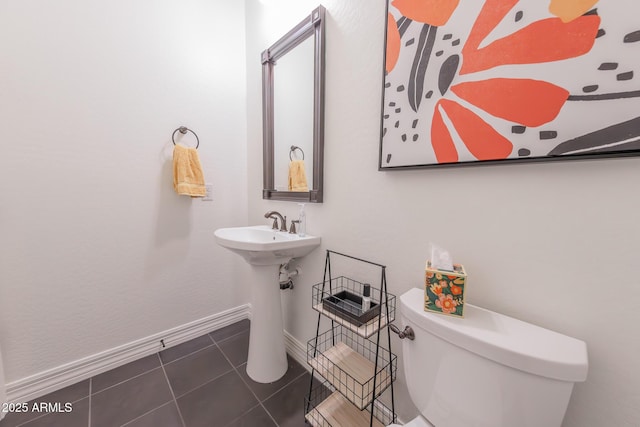 bathroom with sink, tile patterned floors, and toilet