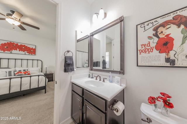 bathroom featuring toilet, vanity, and ceiling fan