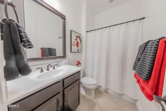 bathroom featuring toilet, tile patterned flooring, and vanity