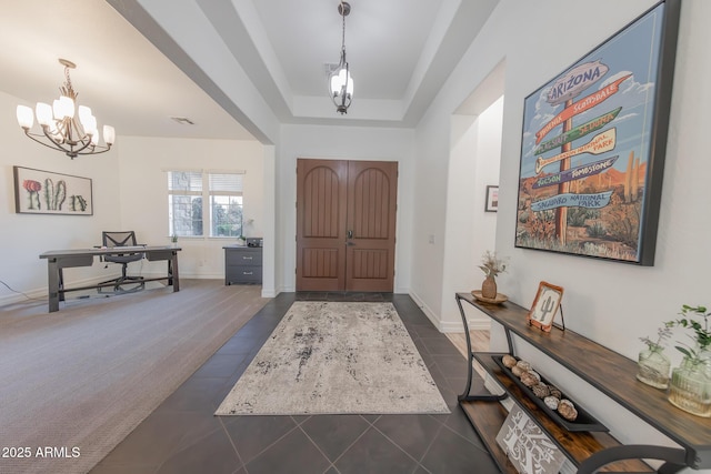 tiled entrance foyer featuring an inviting chandelier