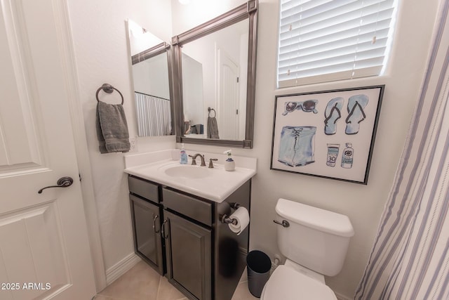 bathroom with toilet, tile patterned floors, and vanity