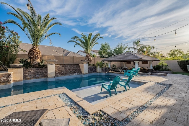 view of swimming pool with a patio area and a gazebo