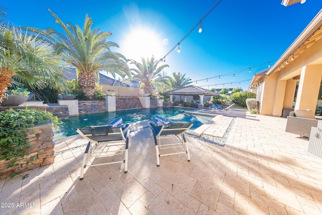 view of swimming pool with a gazebo and a patio