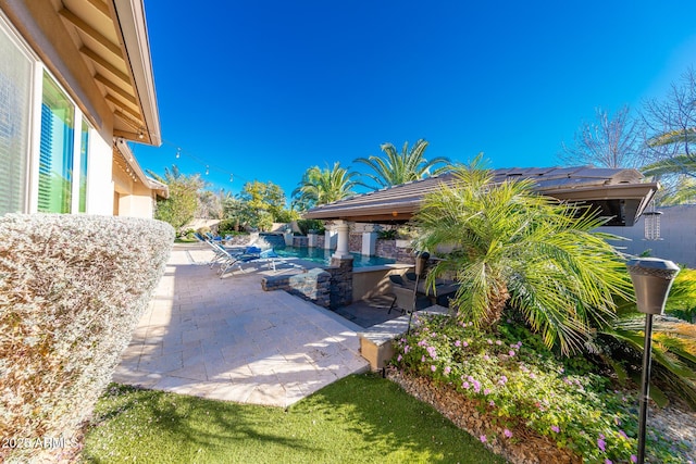 view of patio with an outdoor bar and a pool