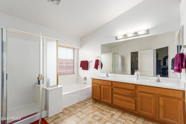 bathroom with vanity, vaulted ceiling, and shower with separate bathtub