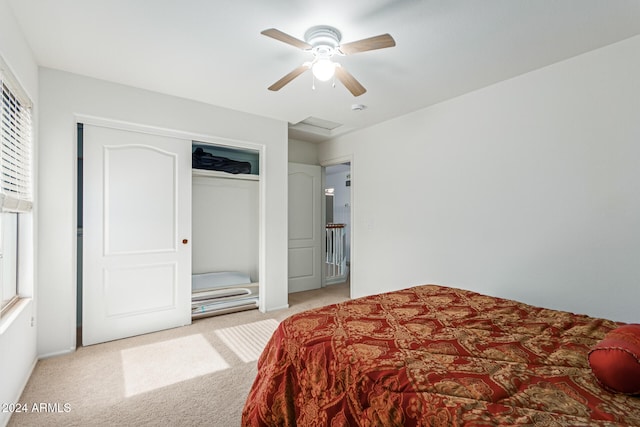 carpeted bedroom with a closet and ceiling fan