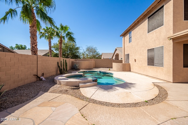 view of swimming pool with a patio and an in ground hot tub