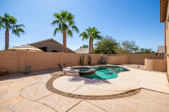 view of swimming pool featuring an in ground hot tub and a patio