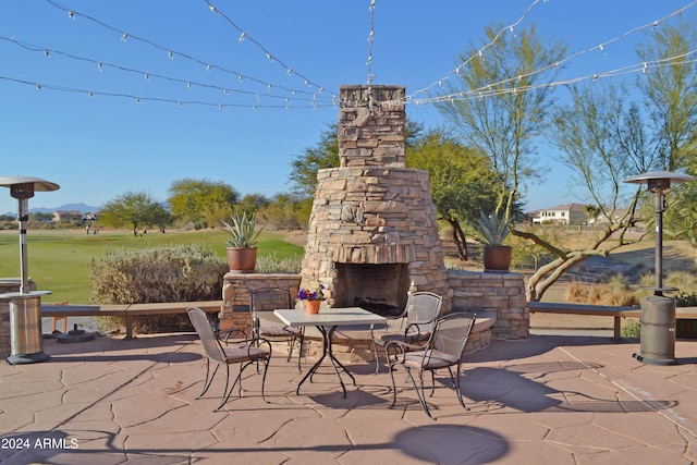 view of patio / terrace with an outdoor stone fireplace