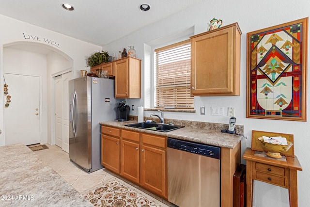 kitchen featuring light tile patterned floors, stainless steel appliances, and sink