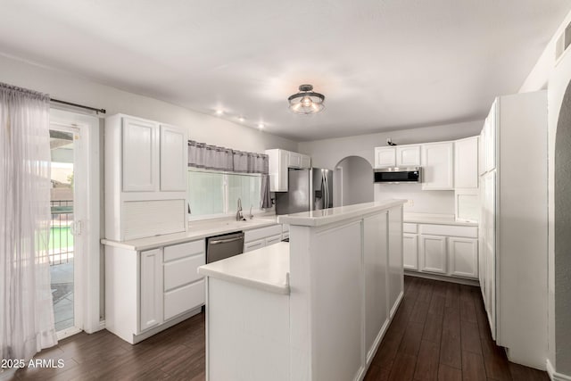 4419 W Vogel Ave, Glendale, AZ 85302 - kitchen with stainless steel appliances, dark wood-style flooring, a center island, and white cabinetry