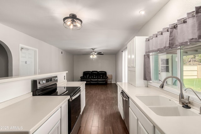 4419 W Vogel Ave, Glendale, AZ 85302 - kitchen featuring stainless steel appliances, white cabinetry, light countertops, a ceiling fan, and dark wood-type flooring