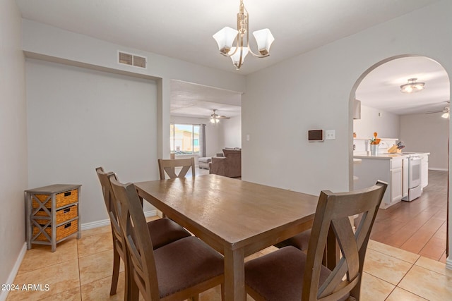 4419 W Vogel Ave, Glendale, AZ 85302 - dining space with ceiling fan, arched walkways, a chandelier, and light tile patterned floors