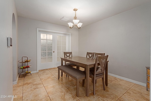 4419 W Vogel Ave, Glendale, AZ 85302 - dining area featuring arched walkways, light tile patterned floors, a chandelier, and french doors