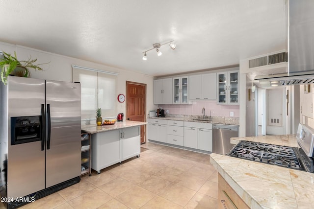 kitchen with white cabinets, sink, appliances with stainless steel finishes, and tasteful backsplash