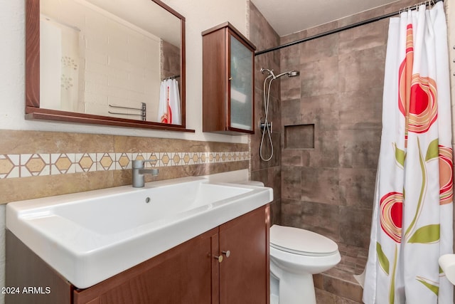 bathroom featuring curtained shower, vanity, tile walls, and toilet