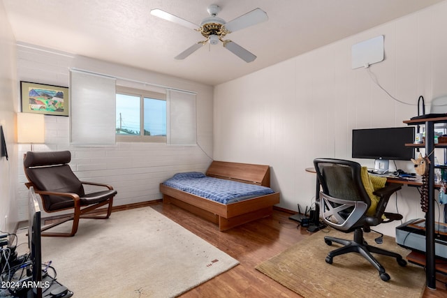 bedroom with wood-type flooring and ceiling fan