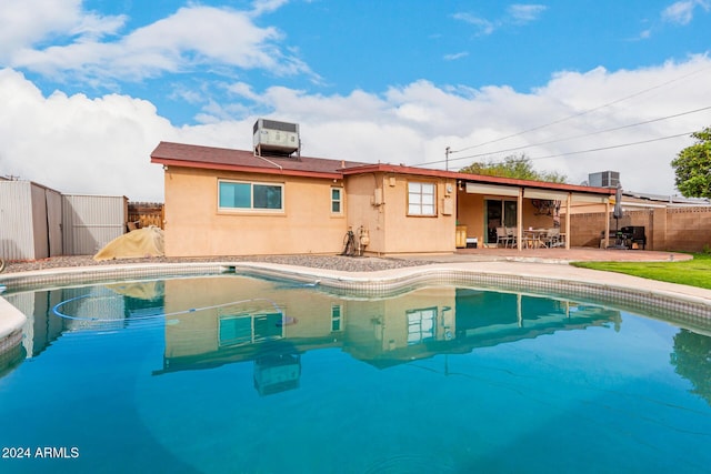 view of pool with a patio area and central AC unit