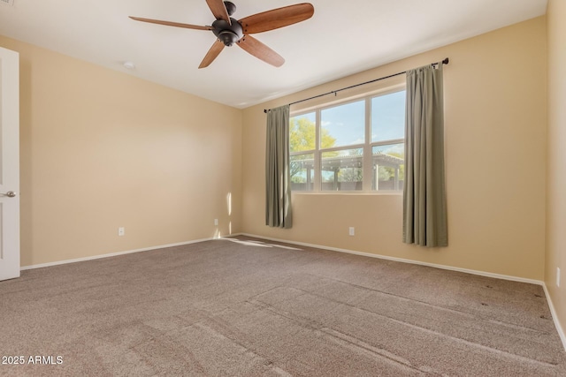 spare room featuring carpet floors, baseboards, and a ceiling fan