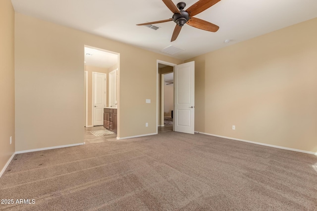 unfurnished bedroom featuring baseboards, ceiling fan, connected bathroom, and light colored carpet