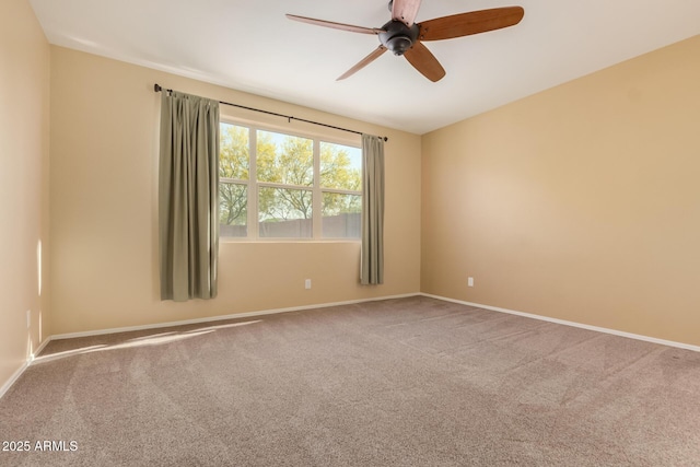 unfurnished room featuring baseboards, a ceiling fan, and carpet flooring