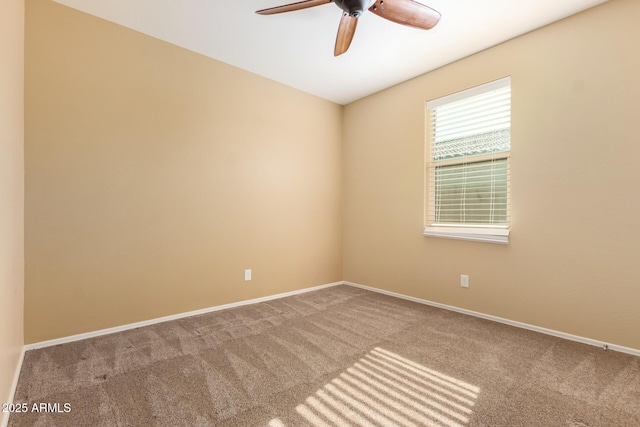carpeted spare room with ceiling fan and baseboards