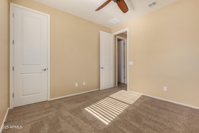 unfurnished bedroom with visible vents, carpet, ceiling fan, and baseboards