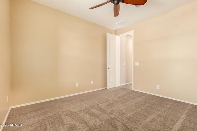 empty room featuring visible vents, a ceiling fan, carpet, and baseboards