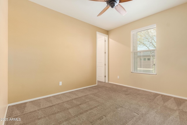 spare room featuring carpet floors, ceiling fan, and baseboards