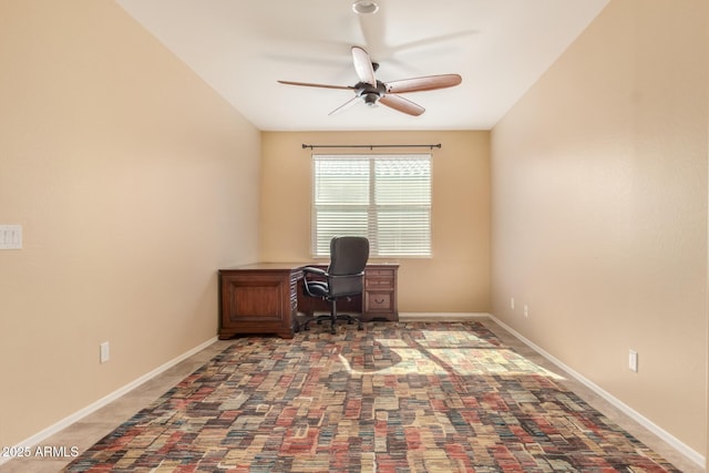 office space featuring baseboards and ceiling fan