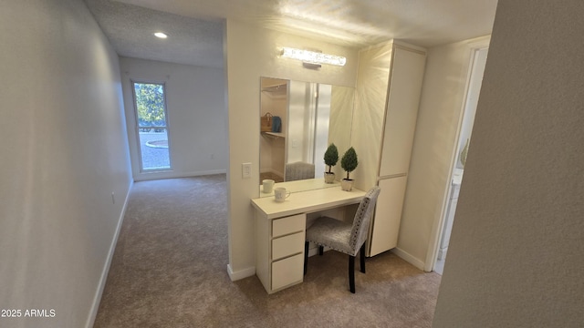 home office featuring a textured ceiling and light colored carpet