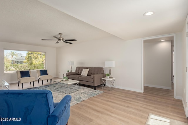 living room featuring light wood-type flooring and ceiling fan