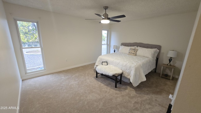 bedroom with light carpet, a textured ceiling, and ceiling fan