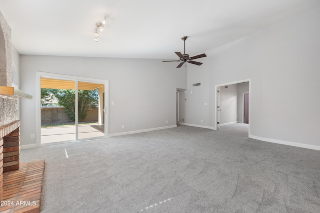 unfurnished living room featuring ceiling fan, a fireplace, carpet floors, and lofted ceiling