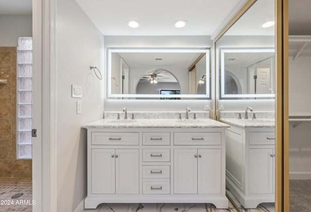 bathroom with vanity, walk in shower, and ceiling fan