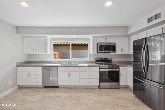 kitchen with white cabinetry, sink, and stainless steel appliances