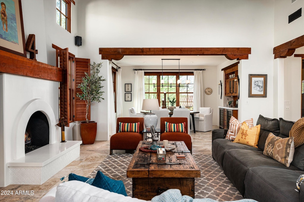 tiled living room featuring a high ceiling and a wealth of natural light